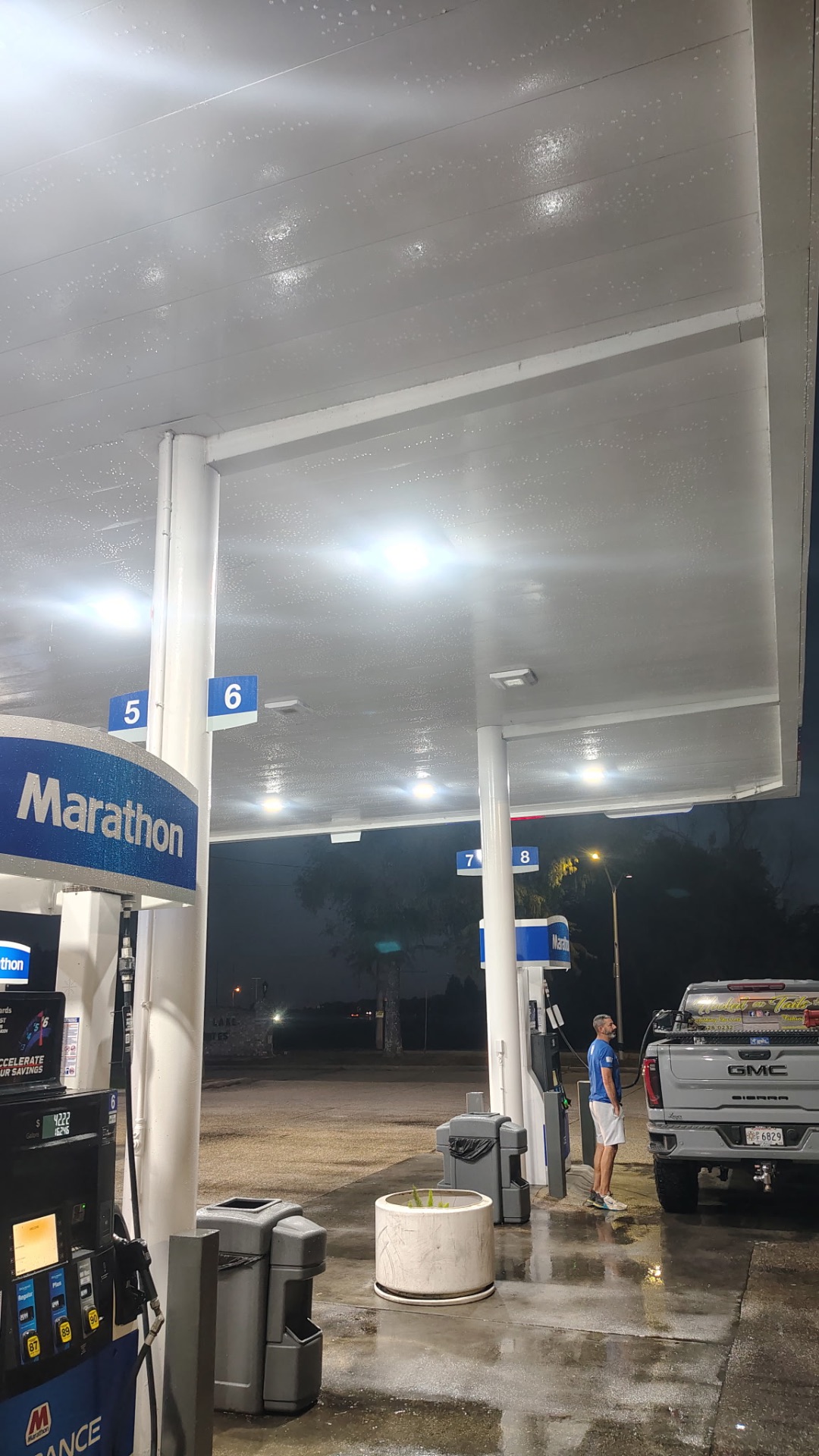 Freshly pressure washed gas station canopy, clean and bright at night